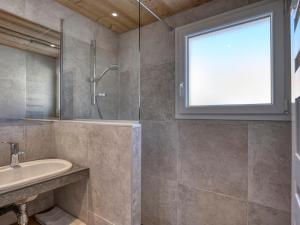 a bathroom with a shower and a sink and a window at Appartement Megève, 2 pièces, 3 personnes - FR-1-453-120 in Megève