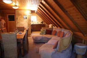 a living room with a couch and a table at Haus Tanne - Obergeschoss Stausee-Hausde in Neumühle