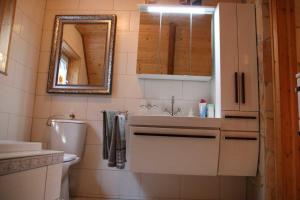 a bathroom with a sink and a toilet and a mirror at Haus Tanne - Obergeschoss Stausee-Hausde in Neumühle