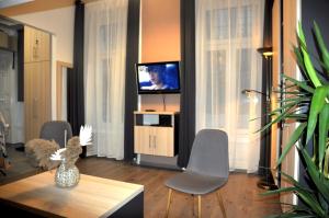 Televízia a/alebo spoločenská miestnosť v ubytovaní Angel's Apartman