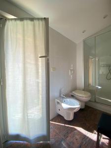a bathroom with a shower and a toilet and a sink at Clelia Apartments - Deiva Marina in Deiva Marina