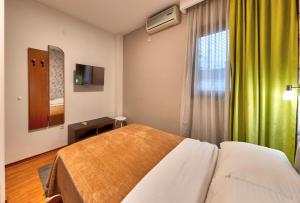 une chambre d'hôtel avec un lit et une fenêtre dans l'établissement Pansion Villa Nur, à Mostar