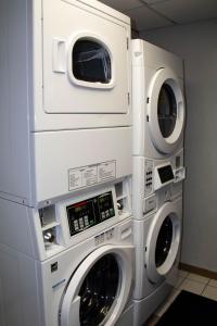 two washing machines stacked on top of each other at New Victorian Inn & Suites-Norfolk in Norfolk