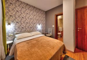 a bedroom with a large bed in a room at Pansion Villa Nur in Mostar