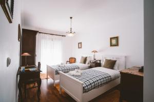 a bedroom with two beds and a table at Best Houses 31 - Seashell House in Baleal