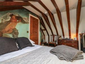 a bedroom with a bed with a painting on the wall at St Edmunds Church in Bridlington