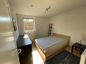 a small bedroom with a bed and a window at Villa Fuchsbau in Hohenfelde