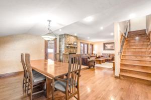 a dining room with a wooden table and chairs at Larkspur Lodge in Avon