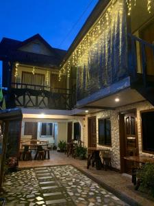 a house with a patio with lights on it at Lola Flor's Guest House in El Nido