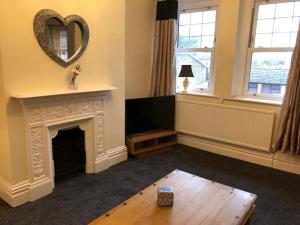 a living room with a fireplace and a mirror at The Newbridge Hotel in Newbridge