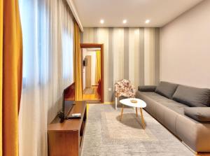 a living room with a couch and a table at Pansion Villa Nur in Mostar