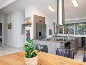 a large kitchen with a wooden table and a dining room at Three-Bedroom Holiday home in Knebel 23 in Knebel