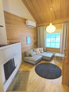 a living room with a couch and a fireplace at Gold Legend Paukkula #4 - Saariselkä Apartments in Saariselka