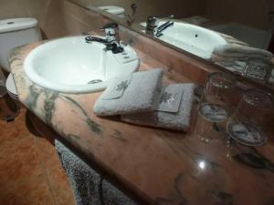 a bathroom with a sink and a counter top at Hotel Brasa in Elvas