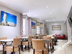 un ristorante con tavoli e sedie in una stanza di Hotel de La Comédie a Montpellier