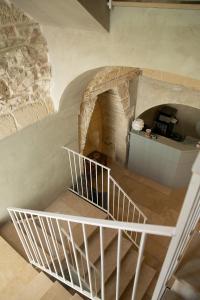 an overhead view of a spiral staircase in a building at Graffiti Living - Santa Rita - Rooms in Corato +67 photos
