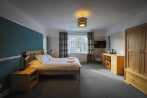 a bedroom with a bed and a television in it at The Star Inn in Lingfield