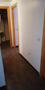 an empty room with a hallway with a tile floor at Apartamento Reina in Alcantarilla
