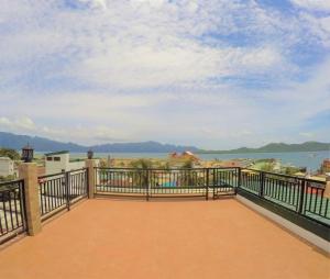 a balcony with a view of the water at ISLANDERS INN - CORON in Coron