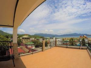 a balcony with a view of a city at ISLANDERS INN - CORON in Coron