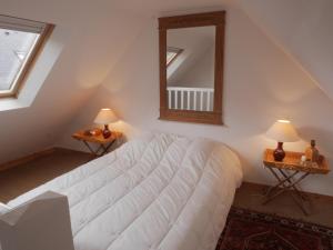 a bedroom with a white bed and a mirror at Maison Sauzon, 5 pièces, 6 personnes - FR-1-418-82 in Sauzon