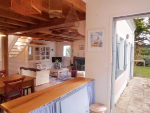 a kitchen and living room of a house with a table at Maison Sauzon, 5 pièces, 6 personnes - FR-1-418-82 in Sauzon