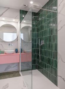 a bathroom with a glass shower and a sink at Stylish apartment - Casa Leone - Center in Trieste