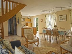 a living room with a table and chairs at Maison de qualité avec jardin paysager à Sauzon - FR-1-418-38 in Sauzon