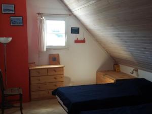 a bedroom with a bed and a dresser and a window at Maison lumineuse avec jardin à Sauzon, proche plage - FR-1-418-70 in Sauzon
