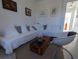 a living room with a white couch and a chair at Appartement Le Palais, 3 pièces, 4 personnes - FR-1-418-80 in Le Palais