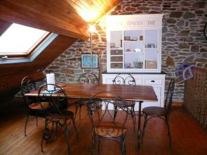 a dining room with a wooden table and chairs at Appartement Le Palais, 3 pièces, 4 personnes - FR-1-418-83 in Le Palais