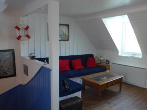 a living room with a blue couch and a table at Appartement Le Palais, 4 pièces, 6 personnes - FR-1-418-58 in Le Palais