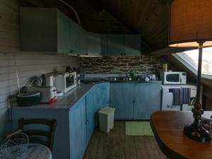 a kitchen with blue cabinets and appliances in a room at Appartement Le Palais, 3 pièces, 4 personnes - FR-1-418-83 in Le Palais