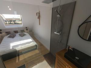 a small bathroom with a bed and a mirror at Maison Le Palais, 4 pièces, 6 personnes - FR-1-418-124 in Le Palais