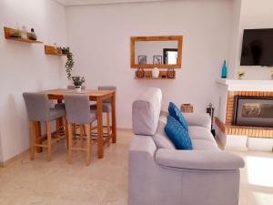 uma sala de estar com um sofá e uma mesa em Pool View Apartment at Jumilla III em Playa Flamenca