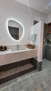 a bathroom with a sink and a mirror at BG Sol e Mar - Chalé Mar in Barra Grande