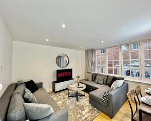 a living room with a couch and a tv at City Centre Luxury Leicester Apartment in Leicester