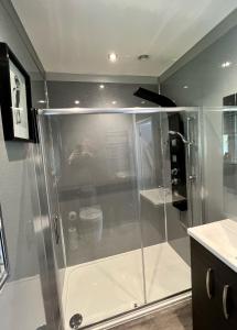 a shower with a glass enclosure in a bathroom at Gamelin in Llangollen +70 photos