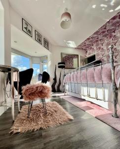 a bedroom with a bed and a table with a stool at Gamelin in Llangollen