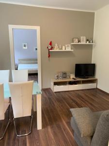 a living room with a table and a television at Apartman Zelengaj in Zagreb