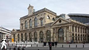 an old building with a clock tower on top of it at Suite Liberte in Lille