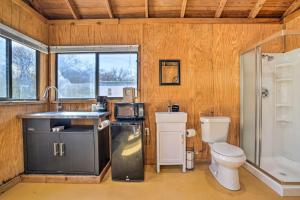 a bathroom with a sink and a toilet and a shower at Laid-Back Vibe! Waterfront Lake Dunlap Studio in New Braunfels +16 photos