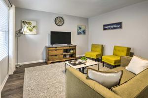 a living room with a couch and a tv at Renovated Raleigh Home half Mi to Downtown! in Raleigh