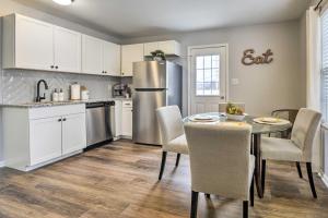 a kitchen with a table and a refrigerator at Renovated Raleigh Home half Mi to Downtown! in Raleigh