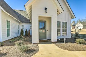 a white house with a green door at Opelika Townhome with Central AandC and Heating! in Opelika