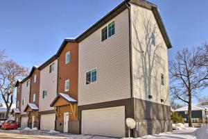 a large brick building with a garage at Modern Fargo Townhome in Central Location! in Fargo