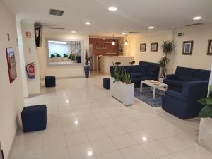 a lobby with blue couches and a living room at Angelus in Fátima