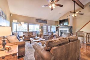 a living room with leather furniture and a ceiling fan at Lakefront Home with Point Venture Golf Access! in Point Venture