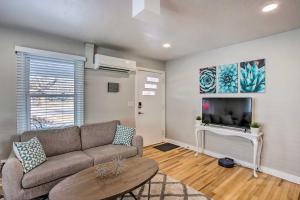a living room with a couch and a tv at Grand Junction Vacation Rental with Fire Pit! in Grand Junction