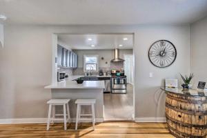 a kitchen with a counter and two stools in it at Grand Junction Vacation Rental with Fire Pit! in Grand Junction